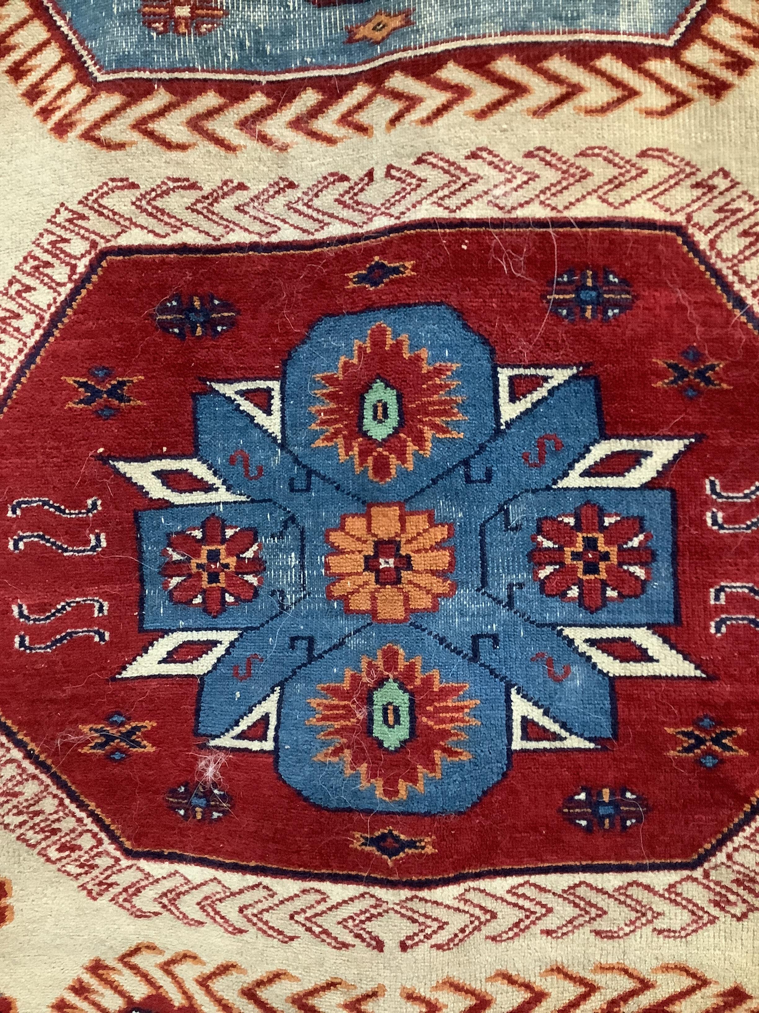 A Caucasian style fawn ground rug, 200 x 132cm
